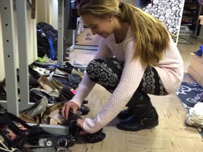 girl looking at shoes in a pile